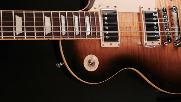 Vintage electric guitar closeup . dark background with copy space
