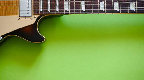 Vintage electric guitar closeup . Color background with copy space