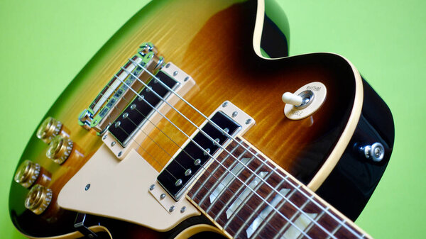 Vintage electric guitar closeup . Color background with copy space