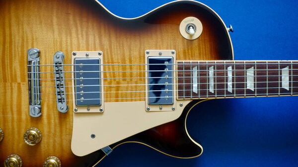 Vintage electric guitar closeup . Color background with copy space