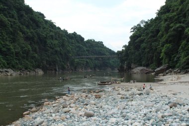 Natural beauty of river bank with mountain blue sky & stony field