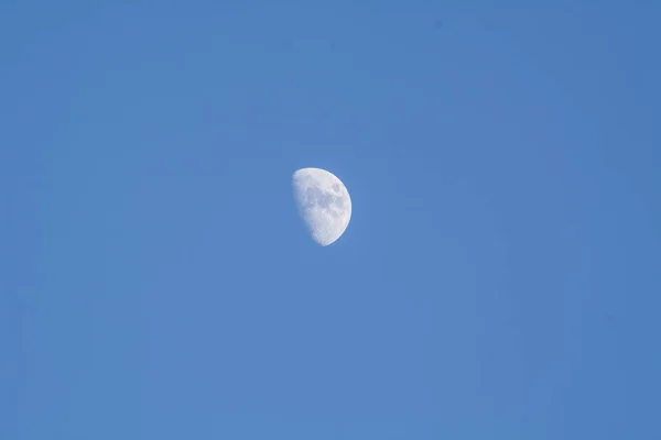 decreasing moon on blue background