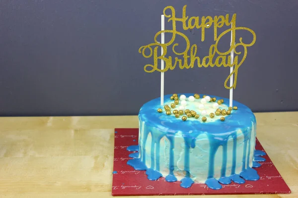 yummy blue color birthday cake with topping and decoration, happy birthday concept