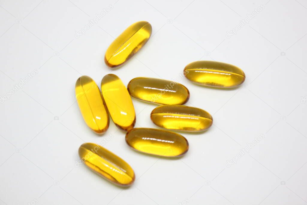 yellow color pills on white background