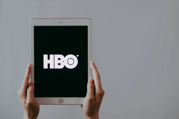 Kézfogás iPad HBO logó képernyő. — Stock Fotó