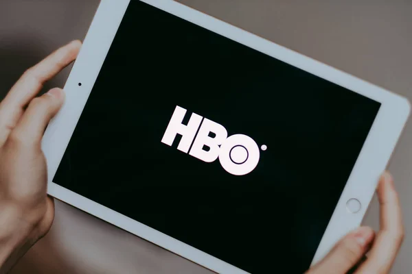 Руки держат iPad с экраном логотипа HBO . — стоковое фото