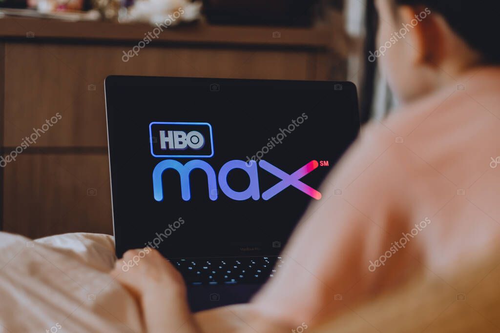 Young female watching HBO channel sitting at home in the evening.