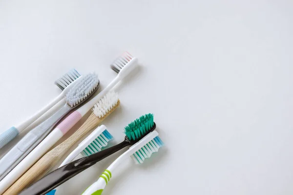 Different types of toothbrushes on a white background. — Stock Photo, Image