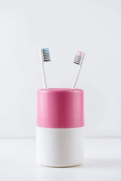 Different types of toothbrushes in a white cup. — Stock Photo, Image