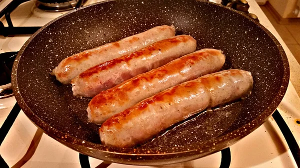 Grilled sausages in a frying pan — Stock Photo, Image