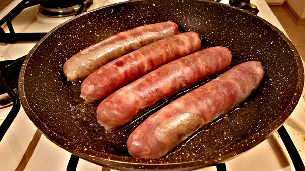 Grilled sausages in a frying pan — Stock Photo, Image