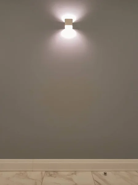 Small interior lamp on a gray wall — 스톡 사진