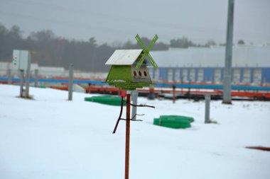 Feeder for birds in a snowy field