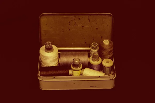 Vintage set of threads for sewing and crafts in an old metal box