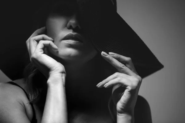 Beautiful portrait of a woman in a big hat. Studio. Close-up.