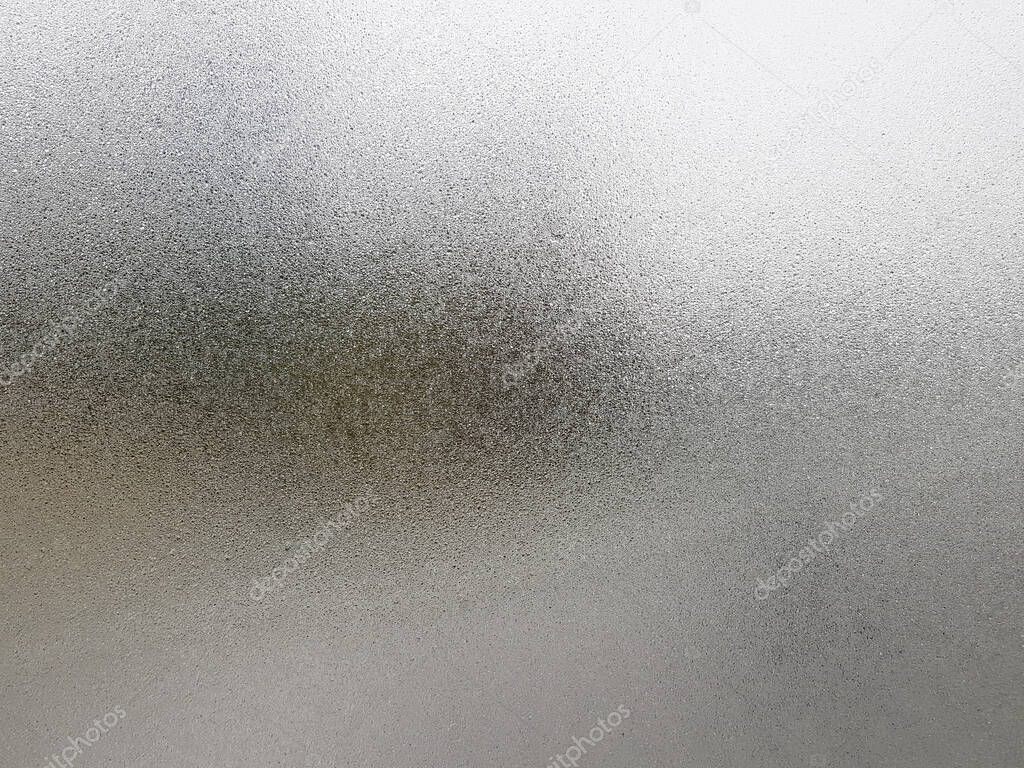 Transparent glass with fog up and water drop on it during winter season.Close up shot of Natural beauty effect. Background and wallpaper concept.