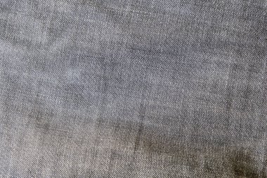 Ağır, mavi gri kot kotlu üst görünümü kumaşın detaylarına yakın çekim yapmış. Tekstil malzemesi ve pamuk sert ve dayanıklı giyim tarzı. Metin için kopyalama alanı olan arkaplan ya da duvar kağıdı