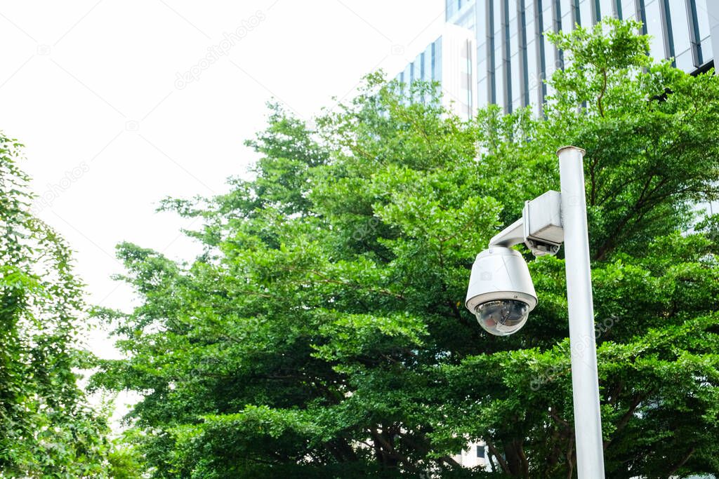Security surveillance camera in front of office building walk way. Record situation around area standard safety system in smart modern building. Help to prevent crime.