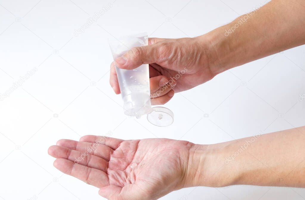 Selective focus of Asian men hand using Alcohol gel, hand sanitizer for personal hygiene on white background to protect, prevent from virus and illness during Corona virus outbreak or Covid 2019.