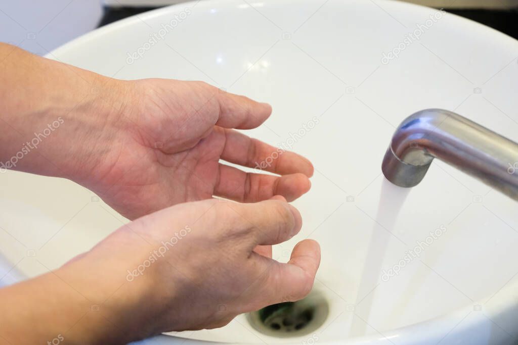 Selective focus of Asian men washing hand with soap and water to clean up. Personal hygiene to prevent and protect virus or illness during Corona Virur, Covid-19 pandemic.