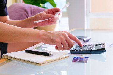 Hesap makinesi kullanan, fatura tutan ve maaşını kişisel gider bütçesi için kontrol eden seçici erkekler. Tasarruf ve ödeme denetimi için bireysel bilanço. Mali ve ekonomi kavramı.