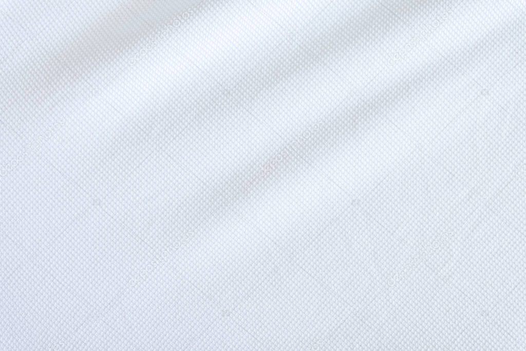 White fabric close up shot of Cotton and polyester shirt. Casual wear over the weekend or summer time season. Background texture concept with copy space for text.