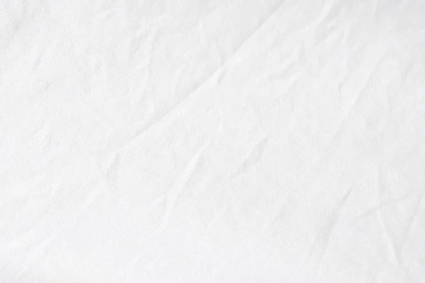 Wrinkled White fabric close up shot of good quality Cotton and polyester shirt. formal wear for office worker . Background texture concept with copy space for text.