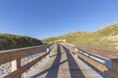 Wooden Boardwalk at Sylt-Wenningstedt at Sunset / Germany