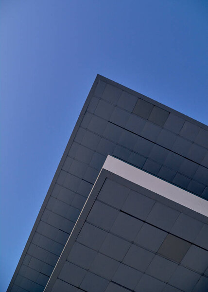 Modernist building roof in blue sky, parallel lines, symmetry, modernism, blue hour