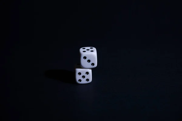 Two dice on black background, Static, horizontal, Two dice on black background, Static, horizontal, one on top of the other