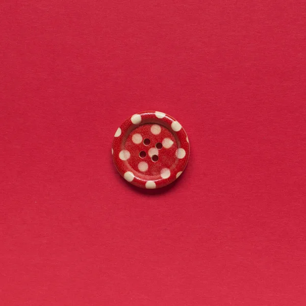 Μονό Κόκκινο Κουμπί Ράψιμο Λευκές Κουκίδες Κόκκινο Φόντο — Φωτογραφία Αρχείου
