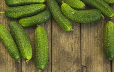 Eski ahşap masada taze salatalıklar. Metin için yeri olan üst görünüm