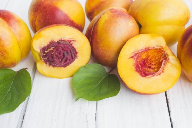 Lezzetli ve sulu şeftali (nektarina) beyaz ahşap masa üzerinde metin için yer var.