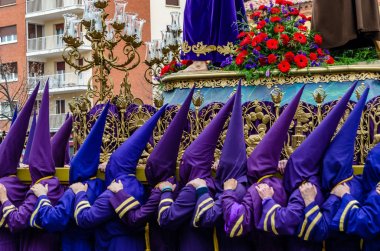Traditional Spanish Holy Week procession in the streets of Palencia, Spain clipart