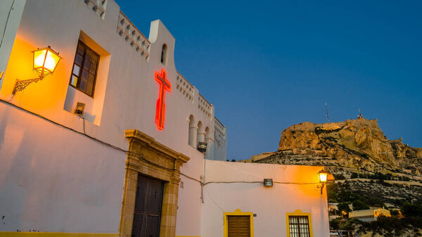 View of the small hermitage of Santa Cruz at dusk, in the Mediterranean city of Alicante, Spain