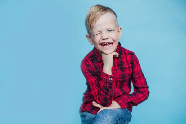 Fashionable little kid with red shirt. Fashion. Style. Studio portrait over blue background — Stock Photo, Image