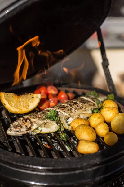 Domates, patates ve sıcak alev üzerinde yemek limon ile lezzetli alabalık balık ızgara. Barbekü. Restoran — Stok fotoğraf