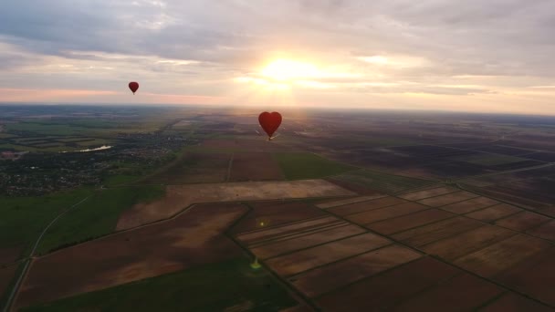 Heißluftballon am Himmel über einer Feldantenne — Stockvideo