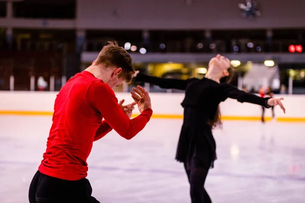The emotional moment of ice dancing, figure skating training of young athletes in a professional arena