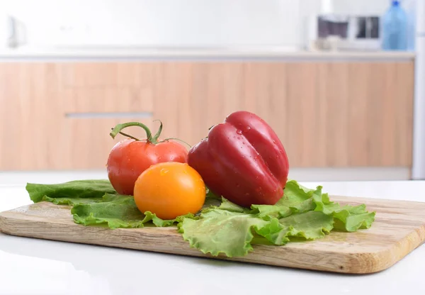 vegetables lie on a wooden board, side view