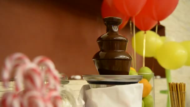 Chocolate fountain The table with dessert. — Stock Video