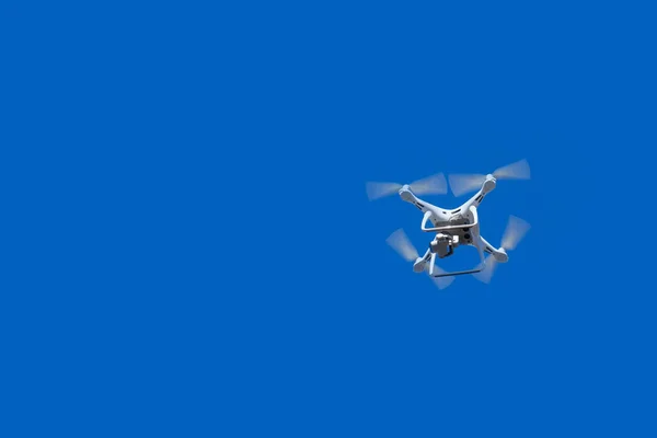Quadcopter in de blauwe lucht. — Stockfoto