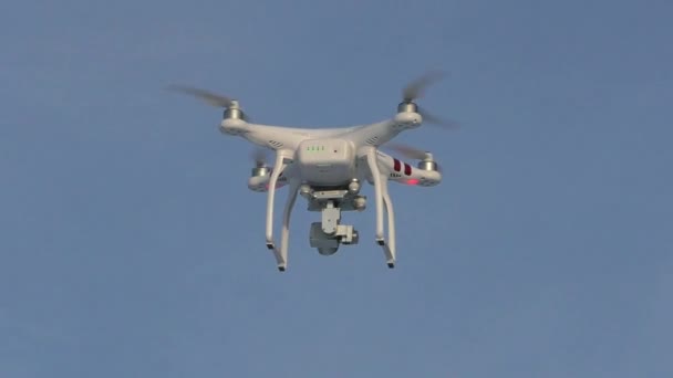 Quadcopter mavi gökyüzünde yükseklerde uçuyor. — Stok video