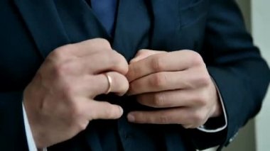 A man dresses in a blue suit.