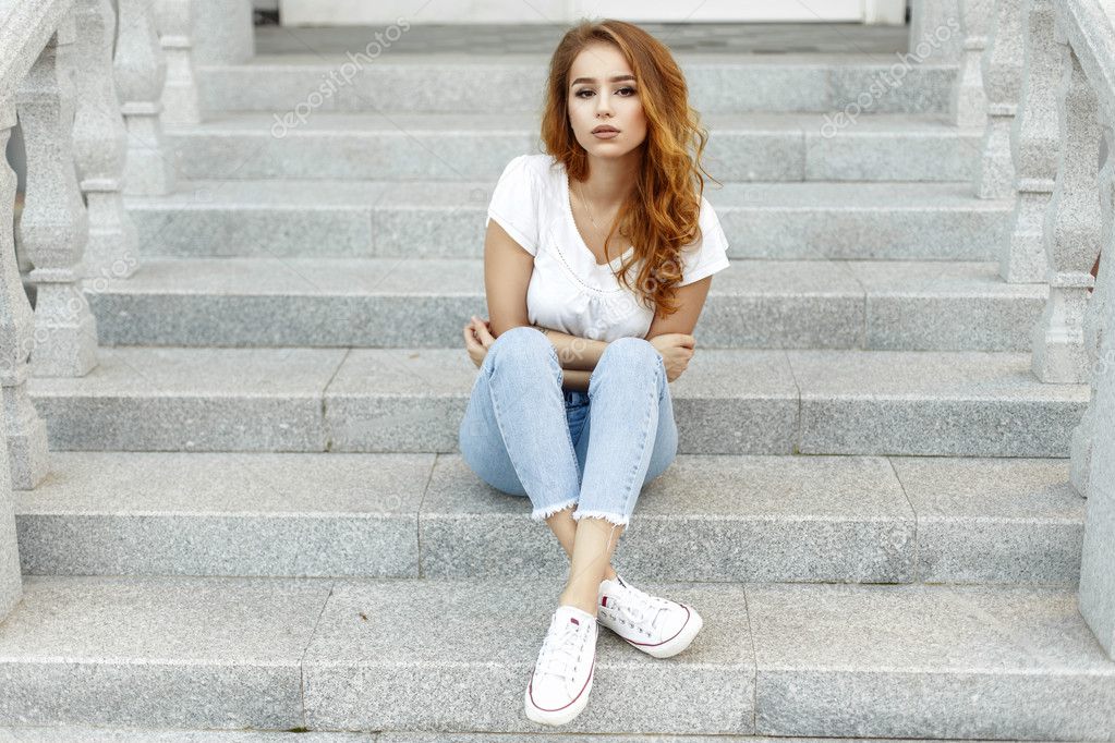 Young Beautiful Girl In A White T Shirt Jeans And Shoes On The Steps Stock Photo By C Alonesdj