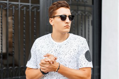 Yakışıklı adam ellerini ovuşturuyor. Dış mekan portresi