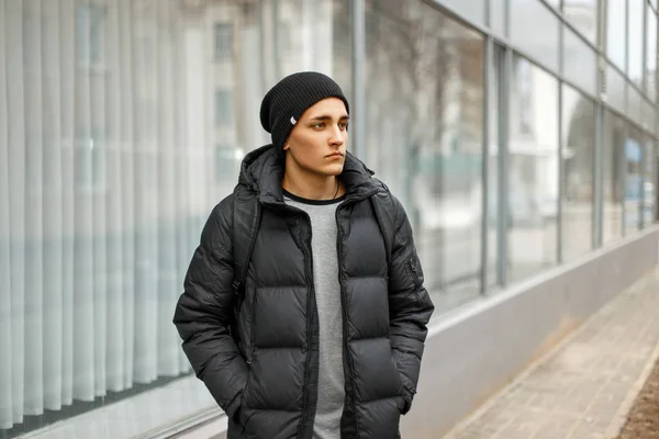 Jóképű férfi téli meleg kabát egy hátizsák, séta a városban — Stock Fotó