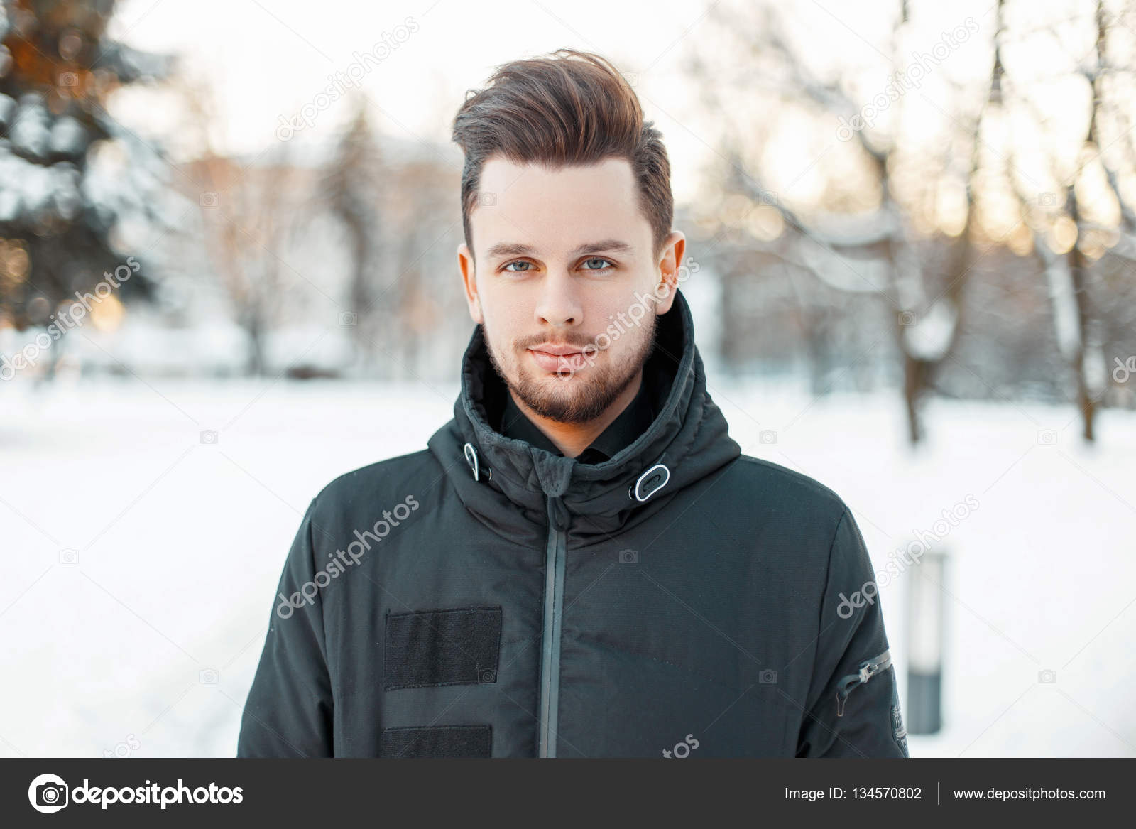 Handsome man with a beard and hairstyle in winter jacket in the park Stock  Photo by ©alonesdj 134570802