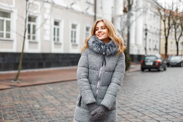 Beautiful woman in winter clothing on a background of the streets