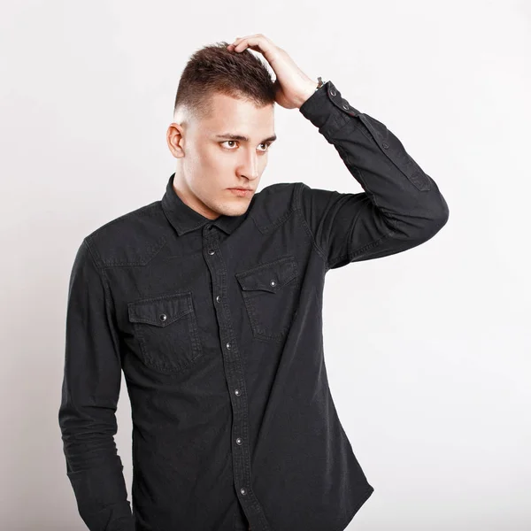 Young man with the hairstyle posing on a white background — Stock Photo, Image